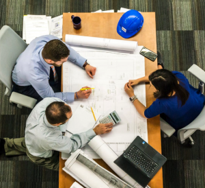 architects sitting around construction plans